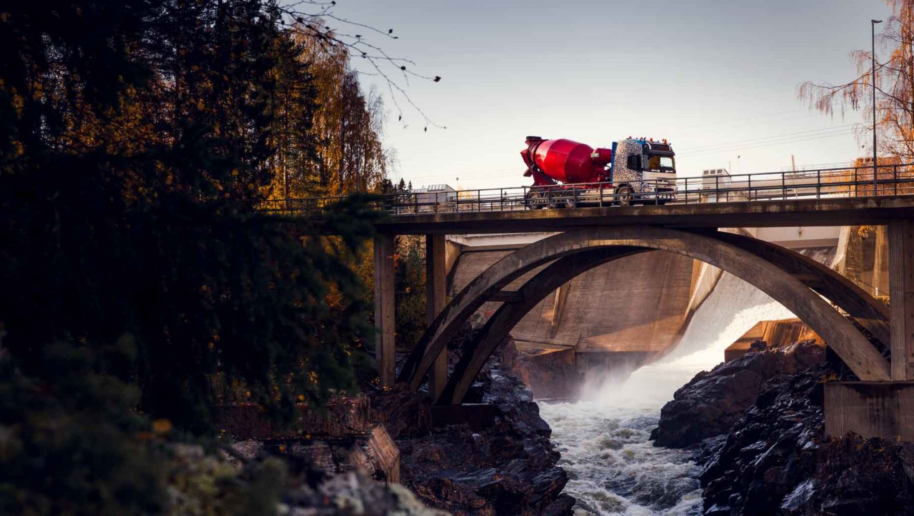 The Volvo FMX driving over a river on a bridge